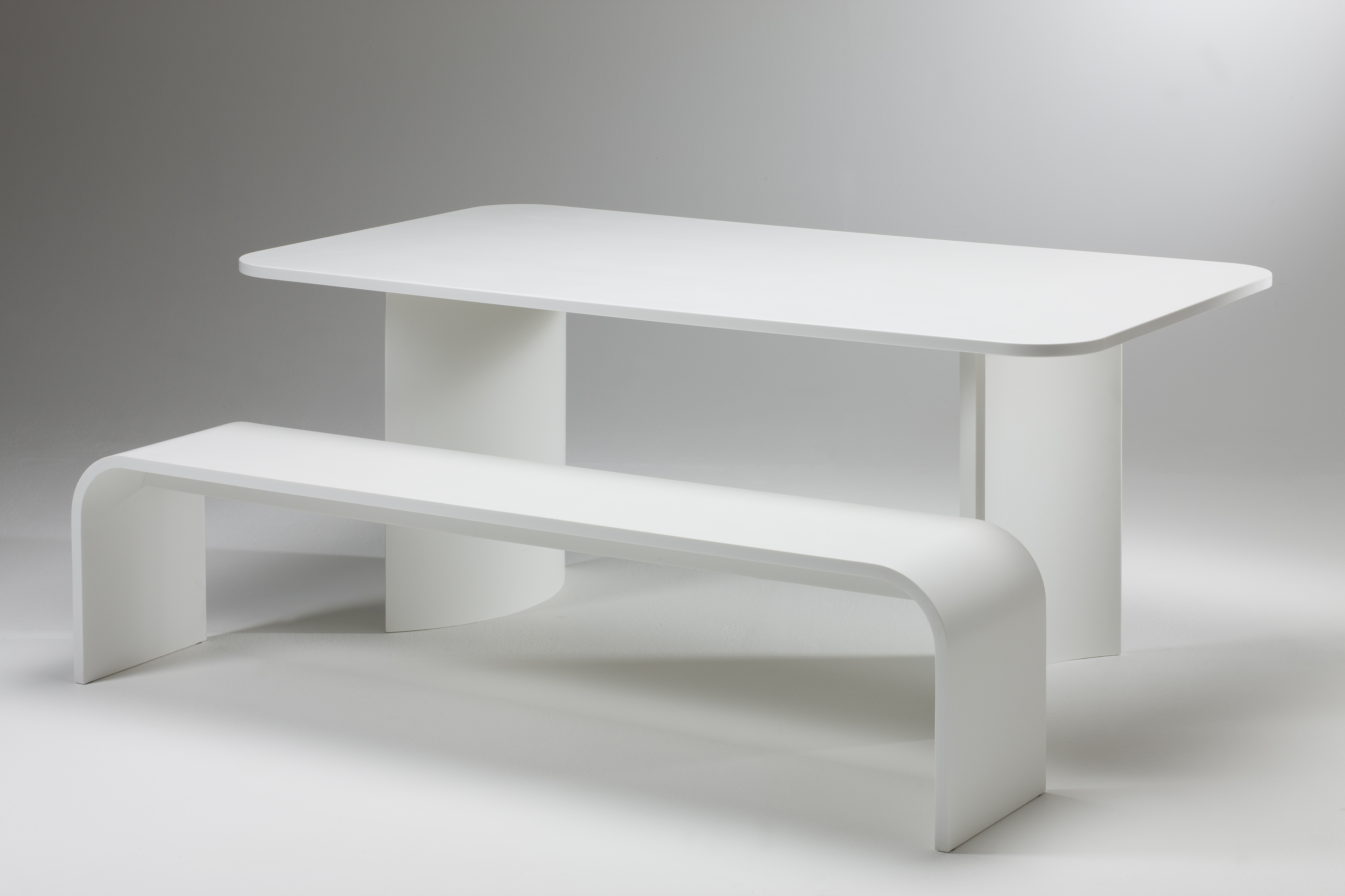 Gravitate, 'Arc' Corian Dining table and bench.